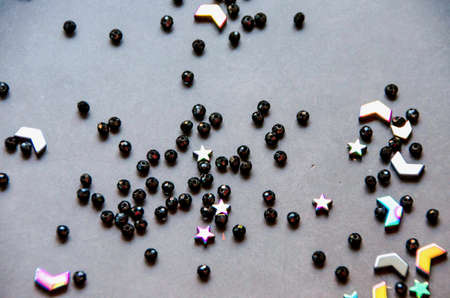Colorful, black beads and stones isolated on white and grey backgroundの写真素材