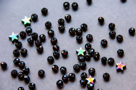 Colorful, black beads and stones isolated on white and grey backgroundの写真素材