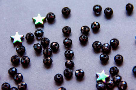 Colorful, black beads and stones isolated on white and grey backgroundの写真素材