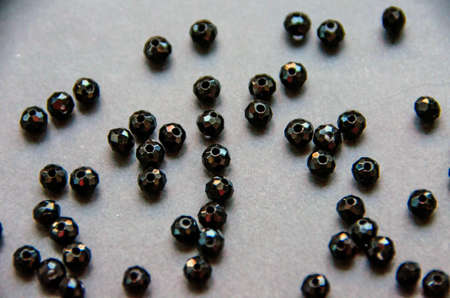 Colorful, black beads and stones isolated on white and grey backgroundの写真素材