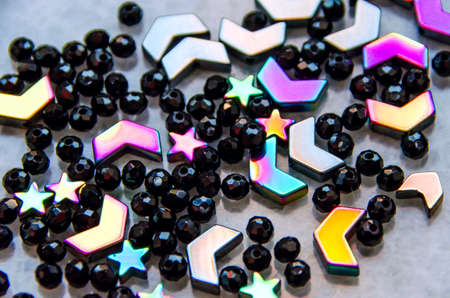 Colorful, black beads and stones isolated on white and grey backgroundの写真素材