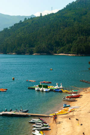 Geres National Park, Portugal - June 7, 2021: River beach with relaxed people enjoying water sports - kayaks, jets and touristic boats - Portugal, Copyspaceのeditorial素材