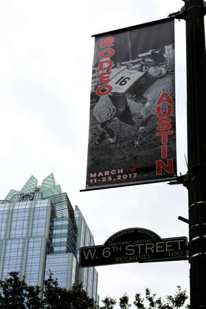 Austin, Texas, March 11-25, 2017 - rodeo advertisement  on 6th street with Frost Bank tower on backgroundのeditorial素材