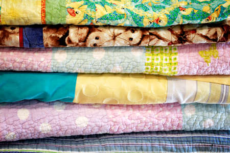 Stock of colorful old washed blankets folded after laundry.の写真素材