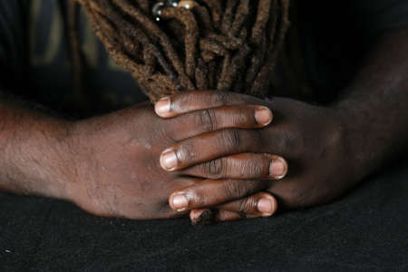 Close up of hands of African-American man holding his dreadlocks styled hairの写真素材