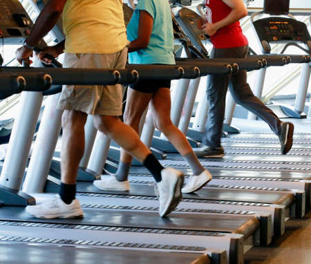 Motion shot of people walking/running in the gymの写真素材