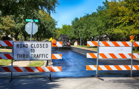 Green and quiet neighborhood street closed for maintenance.    Road closed to thru traffic sign.