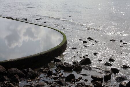 Two kinds of water: river and artificial tank.の写真素材