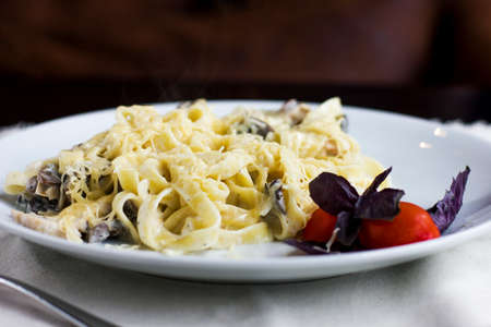 Pasta Carbonara with cheese, tomato and Basilの写真素材