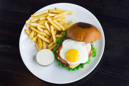 Meat Burger with egg, sauce and friesの写真素材