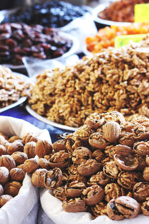 Chopped walnuts and dried fruits in bags at east bazarの写真素材