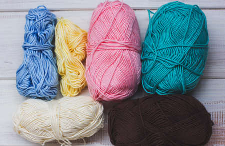 Multicolored cotton yarn on white wooden background. View from topの写真素材
