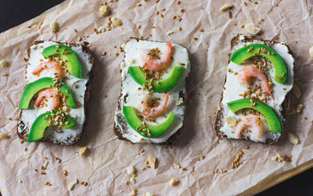 the sandwiches on grain bread with ricotta, shrimp and avocado