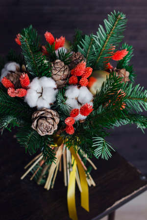 The winter bouquet made of fir branches, Christmas balls and dried flowersの写真素材