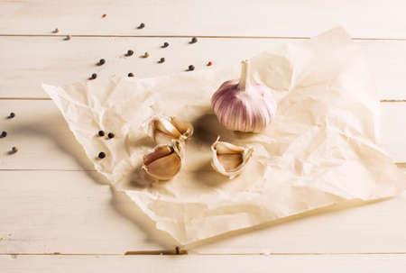 Garlic and peppercorns on white backgroundの写真素材