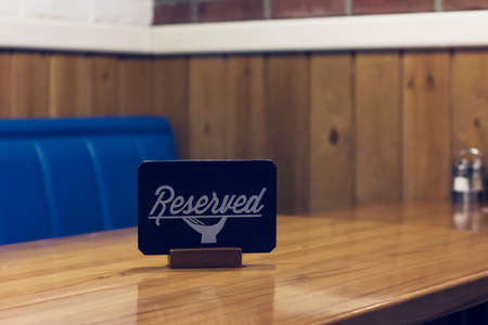 The sign Reserved on the empty table in a cafeの写真素材