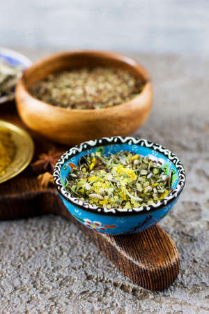Lemon salt with Provencal herbs in a blue Cup on a wooden Boardの写真素材