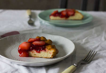 Home made strawberry pie in white plate on tableの写真素材