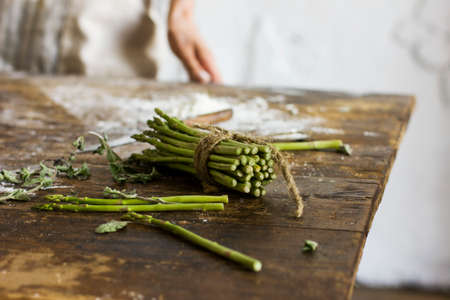 Bunch of asparagus on the kitchen tableの写真素材