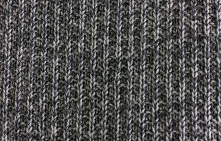 Knitted plaid blanket black grey melange texture background
