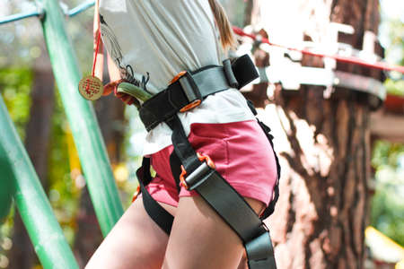 Cute girl 8 years old in adventure rope town, selective focus