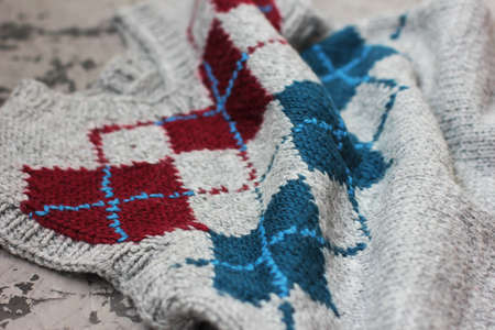 Grey knitted rhombus sweater wool texture background
