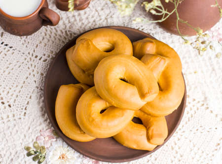 Fresh bagels cookies on rustic serving table