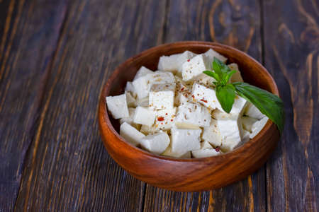 Ricotta cheese cubes in a wooden plateの写真素材