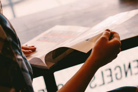 Atmospheric photo of girl with magazine, selective focusの写真素材