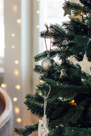 Decorated Christmas tree, minimalist Scandinavian decor backgroundの写真素材