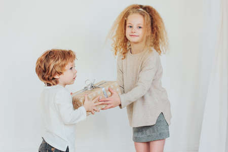 Sister gives gift to younger brother