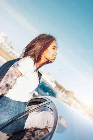 Happpy beautiful charming brunette long hair young asian woman in the black leather jacket near her...
