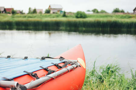 Inflatable catamaran for river rafting and fishing on the grass shore