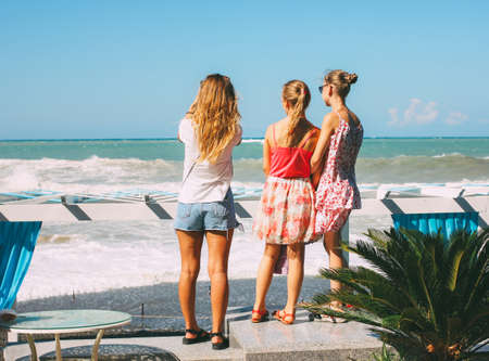 Sochi, Russia - August, 05, 2019. Young girls look at the stormy Black seaのeditorial素材