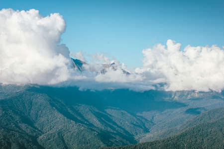Beautiful view of the mountains with big clouds in the blue sky. Krasnodar area, Sochi