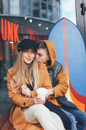 Happy young couple in love teenagers friends dressed in casual style walking together on the city...