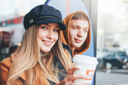 Happy young couple in love teenagers friends dressed in casual style walking together on the city...