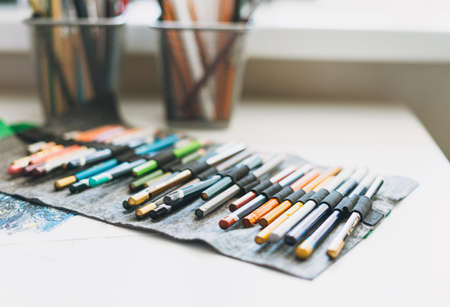 Fabric pencil case with colored pencils close up artist tools selective focus backgroundの写真素材