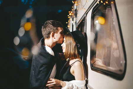 Young couple in love in stylish fashionable outfit romantic weekend wedding trip against background...