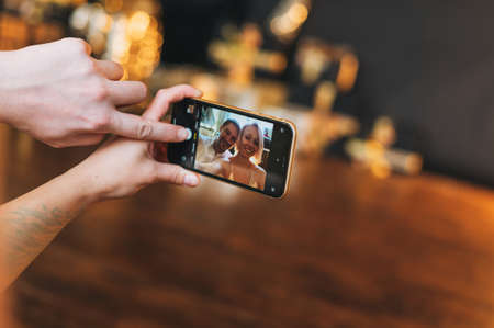 Beautiful happy couple young family taking selfie on mobile phone