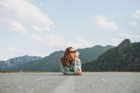 Beautiful smiling young woman traveler in casual clothes on road, trip to mountains, Altaiの写真素材