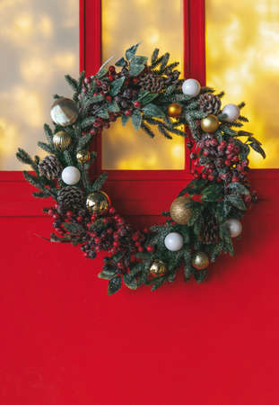 Decorated Christmas tree in golden and white toys with the lights bokeh textured backgroundの写真素材