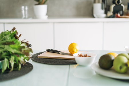 Fresh green fruits and vegetables on table while cooking in kitchen at home