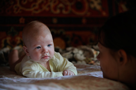 The child looks at his mother from the opposite side in the village house in the ragar of summerの写真素材