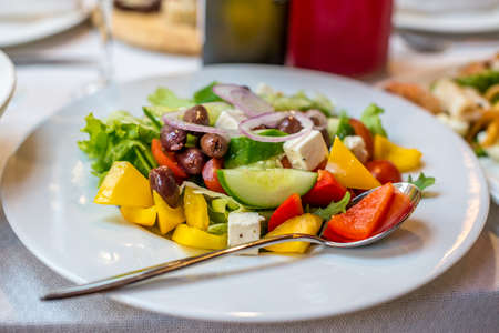 Greek salad with fresh vegetables, feta cheese and black olivesの写真素材