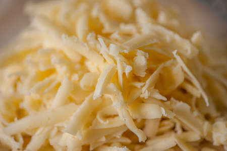 grated cheese on a wooden board and floatの写真素材