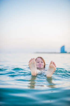 The girl swims in the Mediterranean seaの写真素材