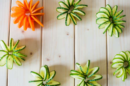 cucumbers and carrots carving on a wooden background