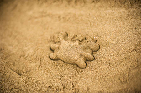 Hand making a sand mold using molds, tools for children to play in the sandの写真素材