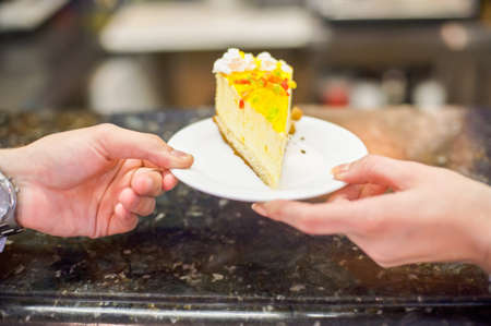 Man and woman take each other cakeの写真素材